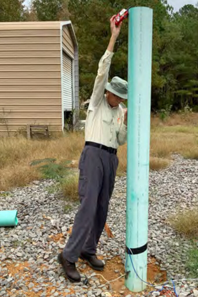 A staffer with the Office of Surface Mining Reclamation and Enforcement takes methane samples at the site of the Griffice home explosion in Oak Grove. Credit: OSMRE